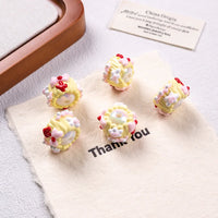 white bead yellow cream red arrow