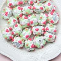 White beads, green flowers, red hearts