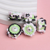 white beads green white black cream white bow black heart